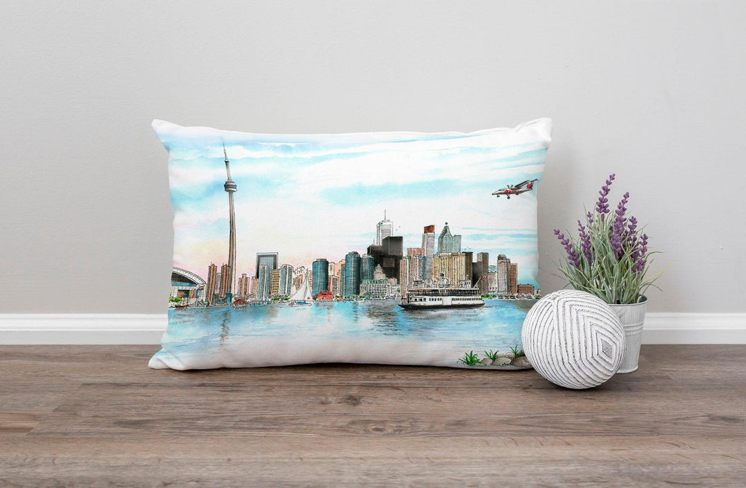 Skyline of Toronto Lumbar Pillow on a floor against a wall 