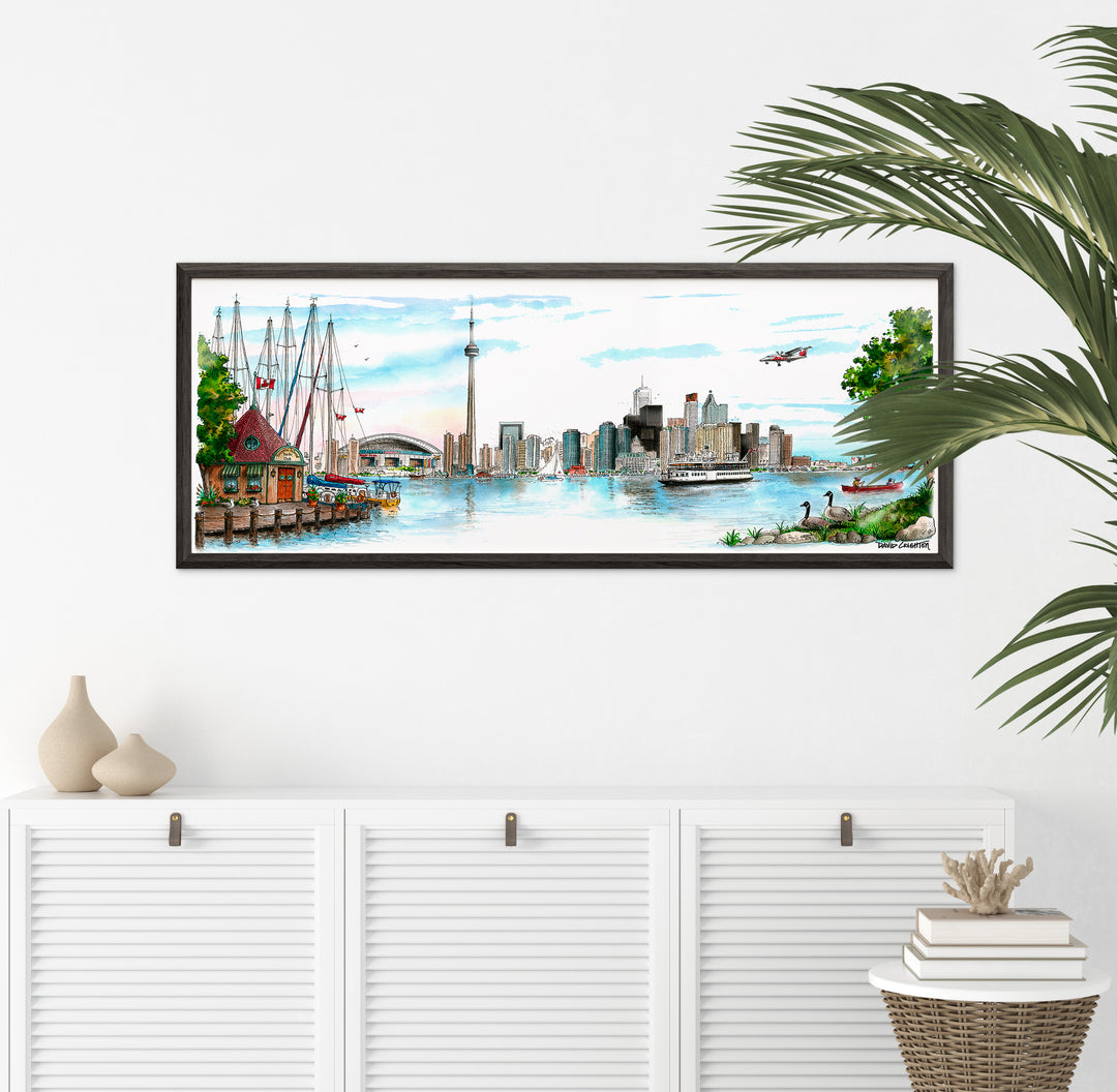 Framed Skyline Wal Art above white buffet with palm plant