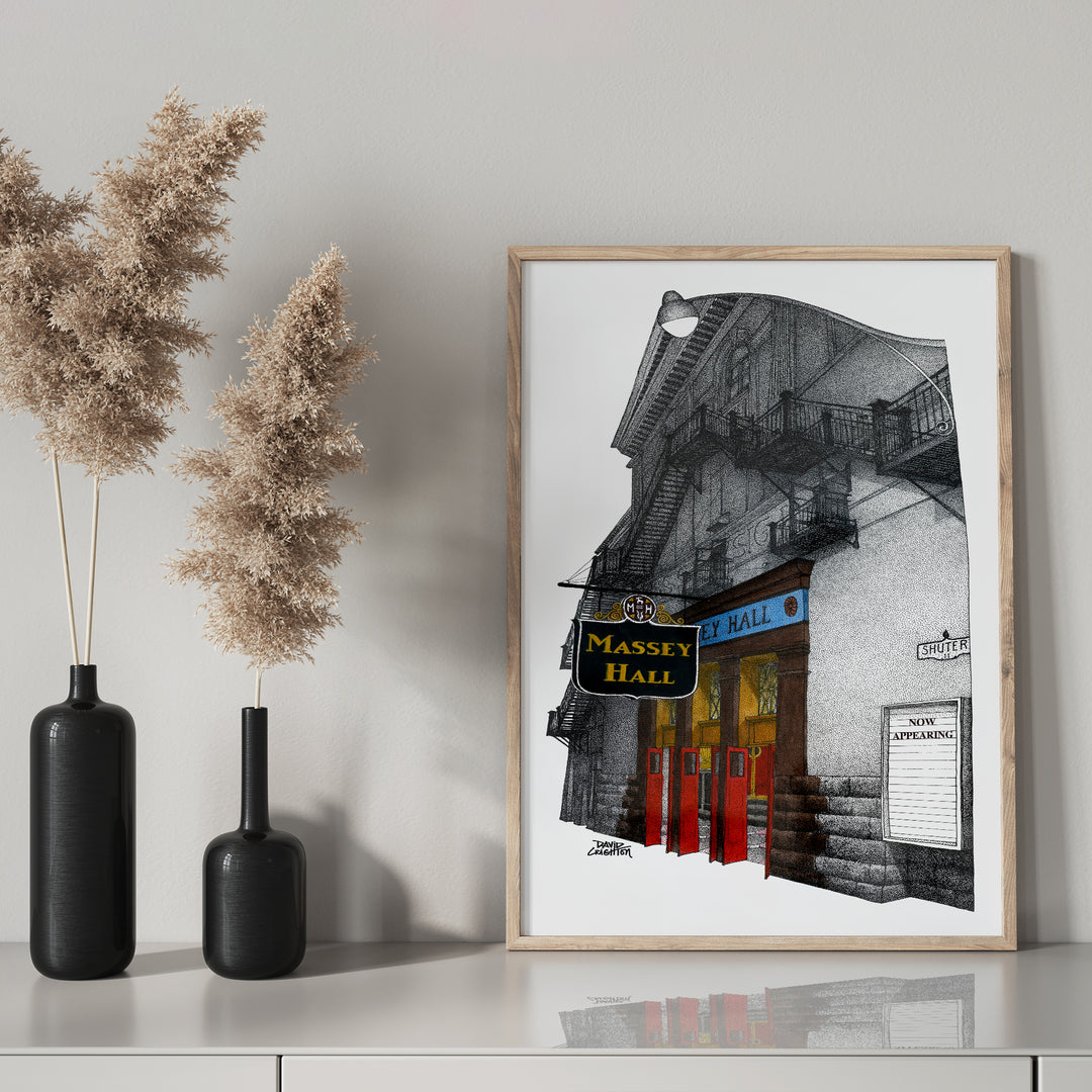 Massey Hall glass framed on mantel with black bottle