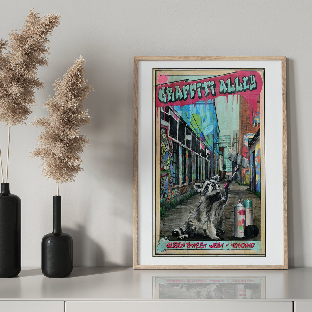 Graffiti Alley Toronto Poster by Rob Croxford in wooden frame on drawer with black mantel bottle