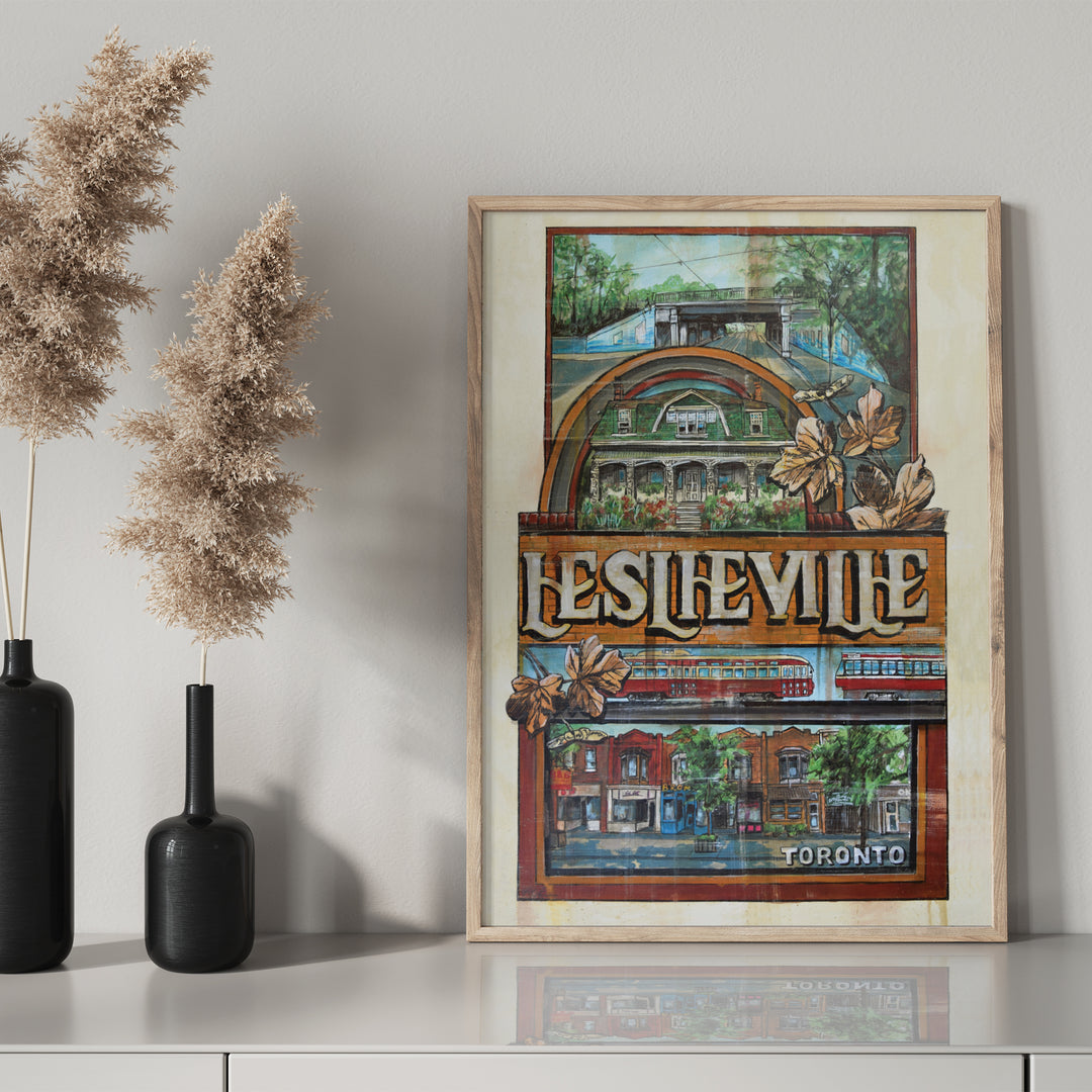 Leslieville Toronto Poster by Rob Croxford in wooden frame on drawer with black mantel bottle