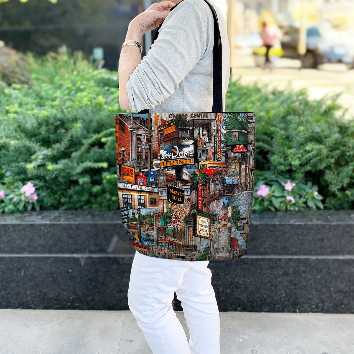 My Toronto Canvas Tote Bag worn by a woman against a hedge