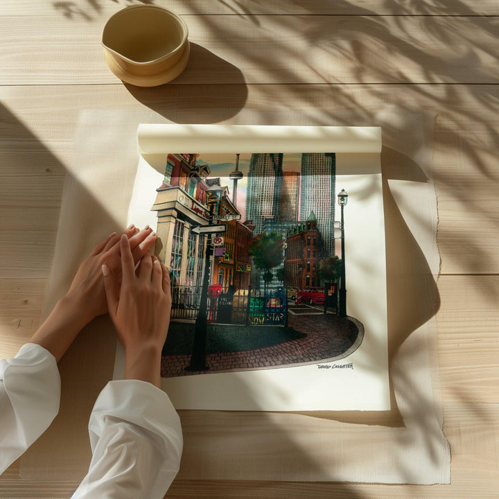 Beautiful illustration of Market Street from Toronto Art Shop on a wooden desk, dappled in sunlight. 