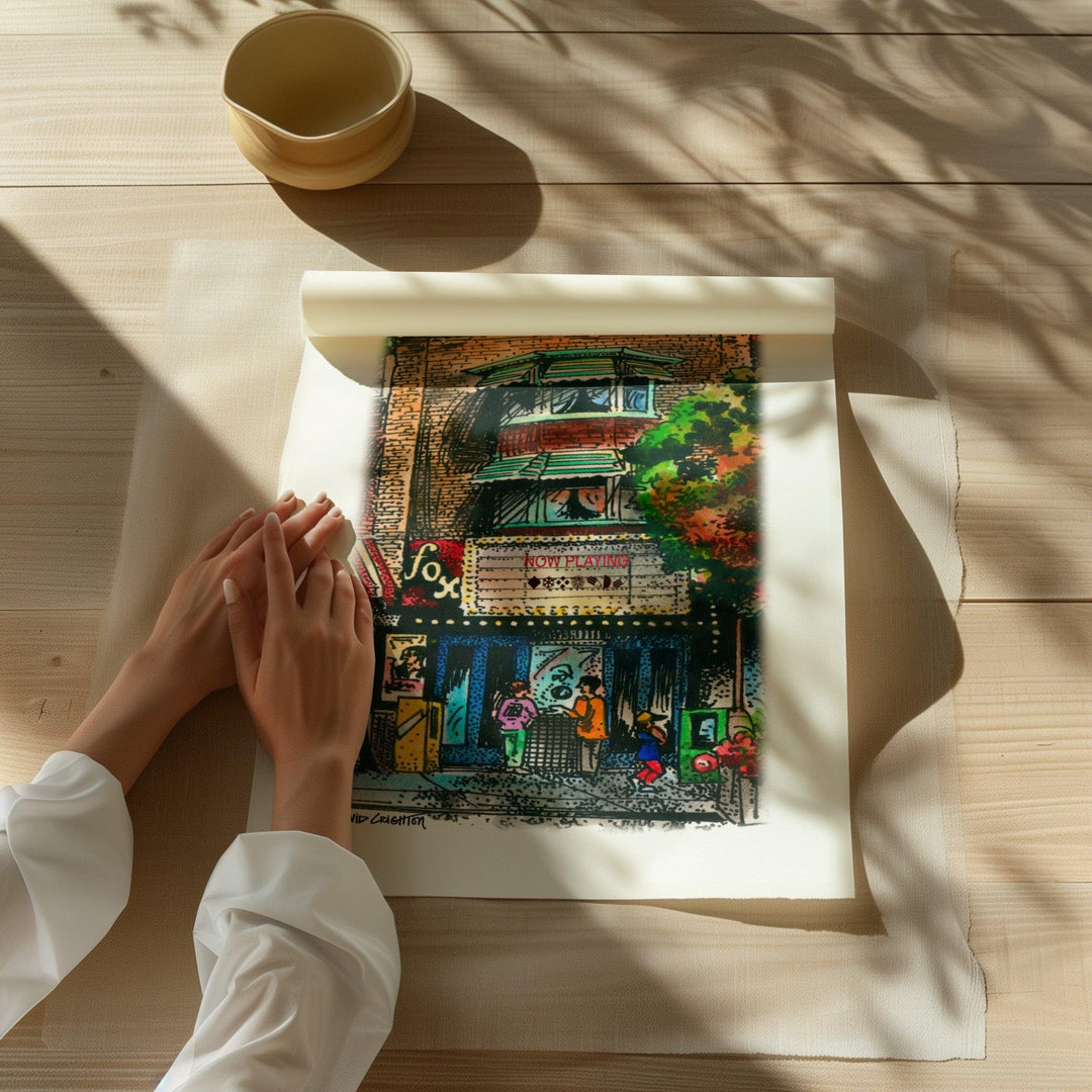 Beautiful illustration of Fox Theatre from Toronto Art Shop on a wooden desk, dappled in sunlight. 