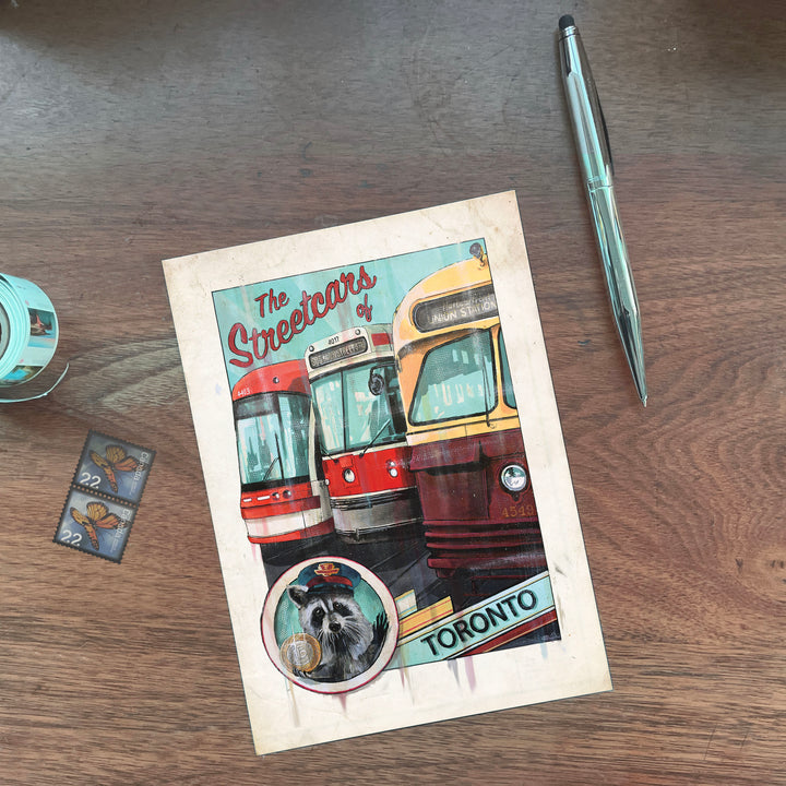 Toronto Racoon Streetcar Postcard on Wood desk with pen and stamps