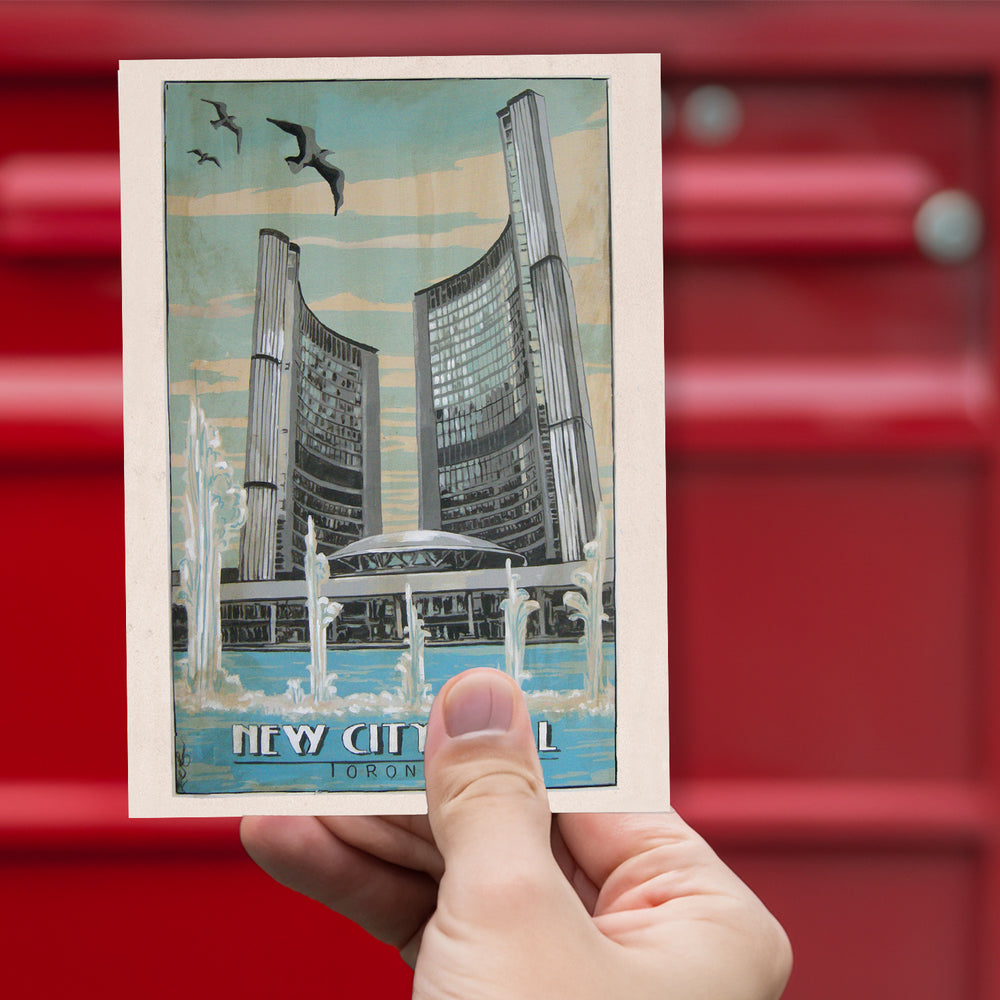 New City Hall Toronto Postcard by Rob Croxford being held up against a red mailbox