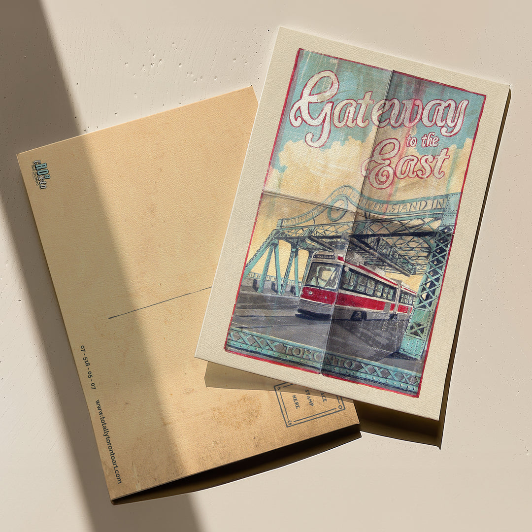 Gateway to the East Postcard by Rob Croxford with back and front of Postcard against table