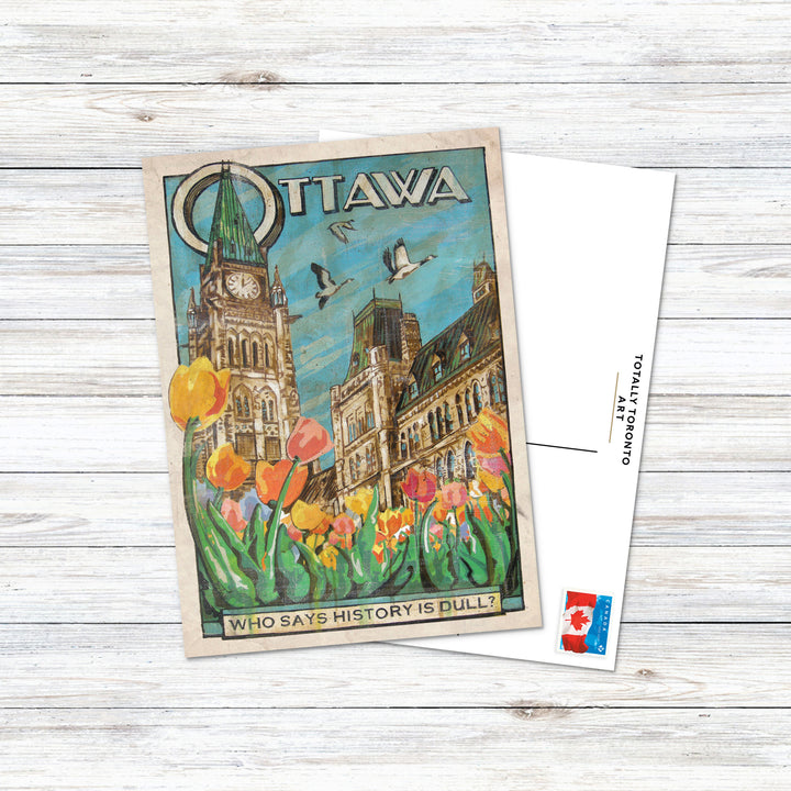 Ottawa Canada Postcard by Rob Croxford on white wood desk with stamp