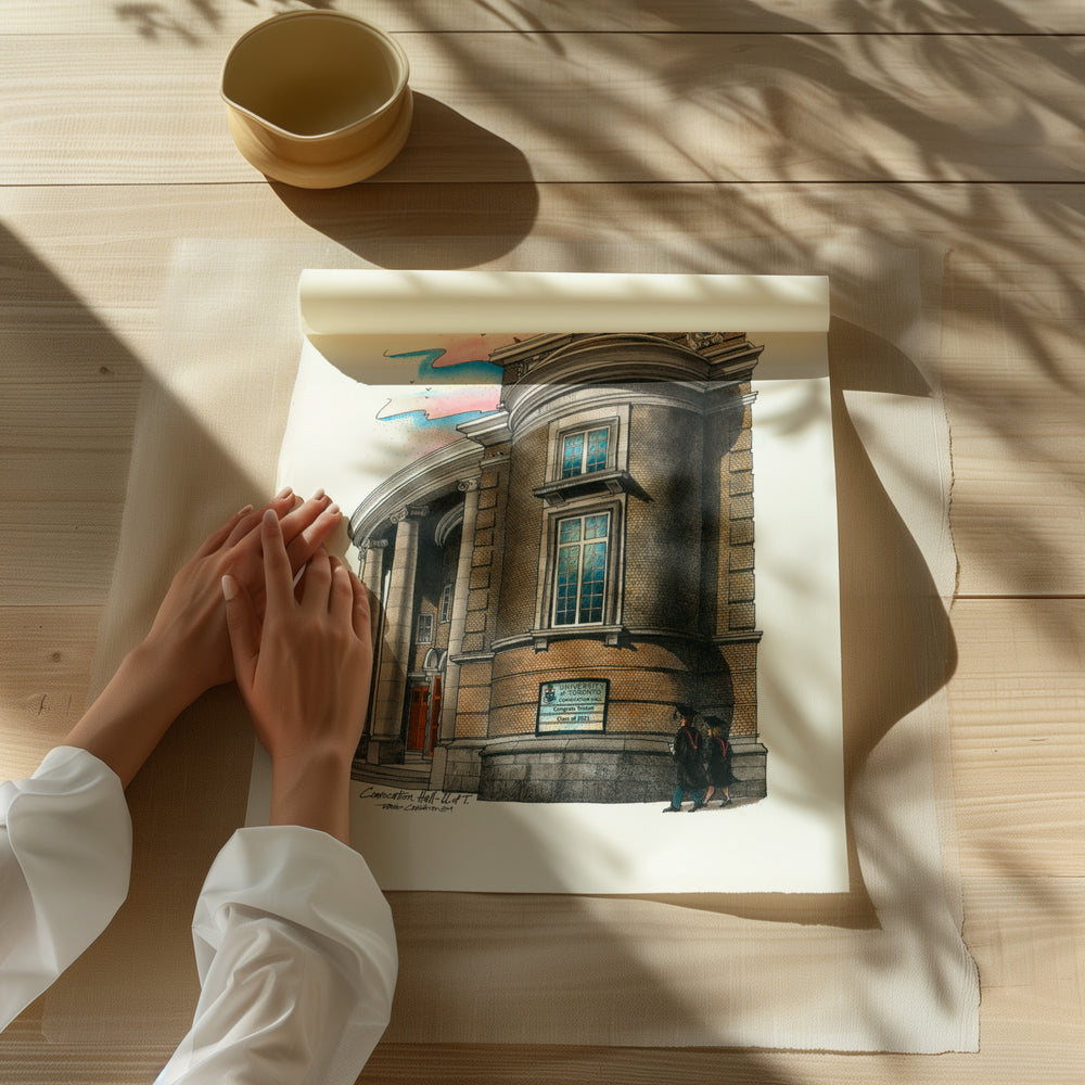 Beautiful illustration of UofT Convocation Hall from Toronto Art Shop on a wooden desk, dappled in sunlight. 