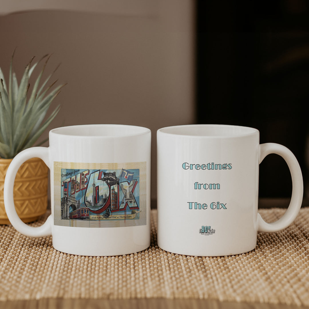 A 6ix Mug with the artwork and another one with the saying