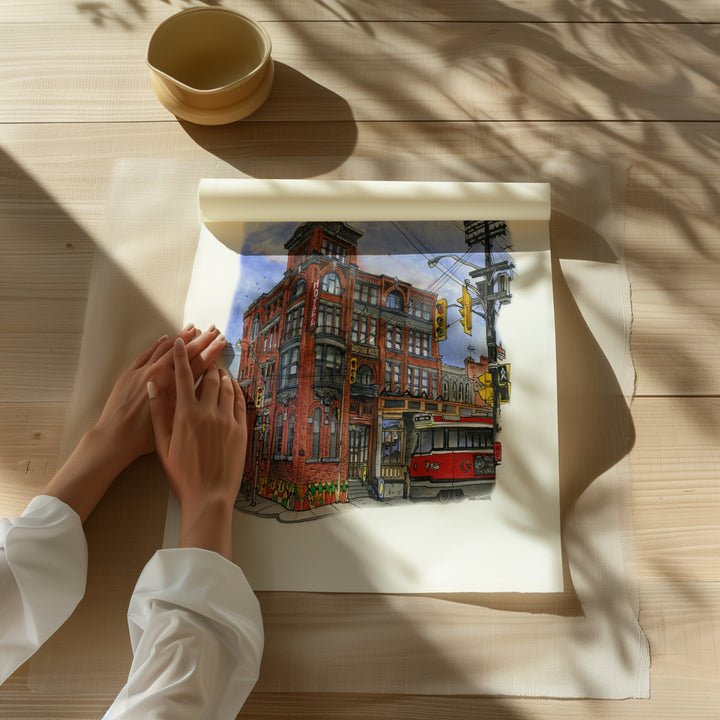 Beautiful illustration of the Gladstone Hotel from Toronto Art Shop on a wooden desk, dappled in sunlight. 