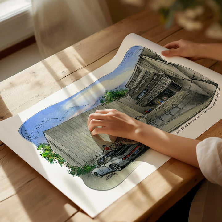 Beautiful illustration of UofT Faculty of Medicine from Toronto Art Shop on a wooden desk, dappled in sunlight. 