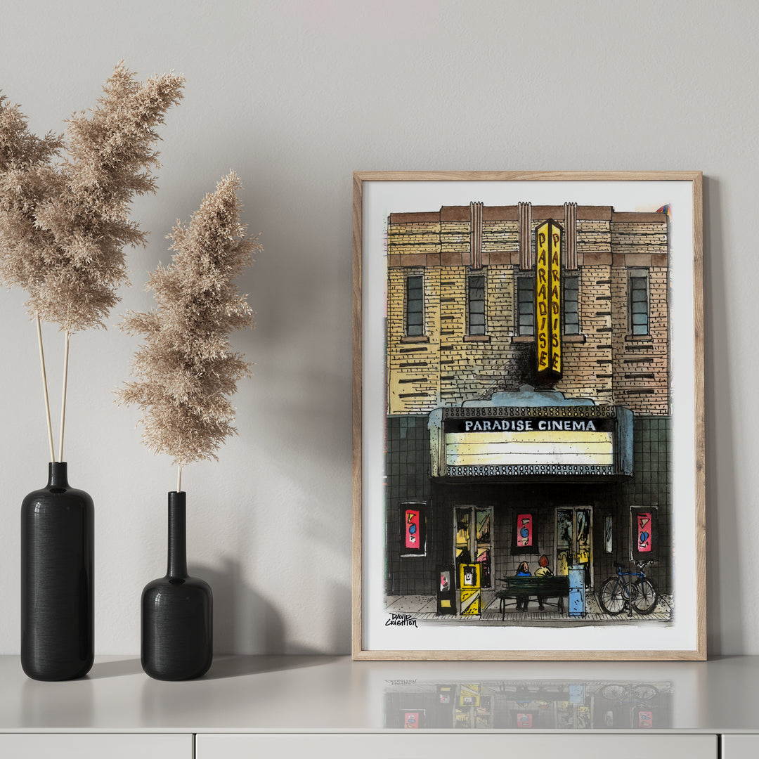 Paradise Cinema glass framed on mantel with black bottle