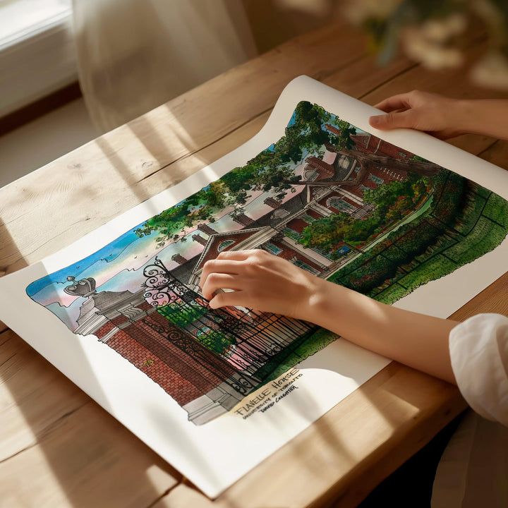 Beautiful illustration of UofT Flavelle House from Toronto Art Shop on a wooden desk, dappled in sunlight. 