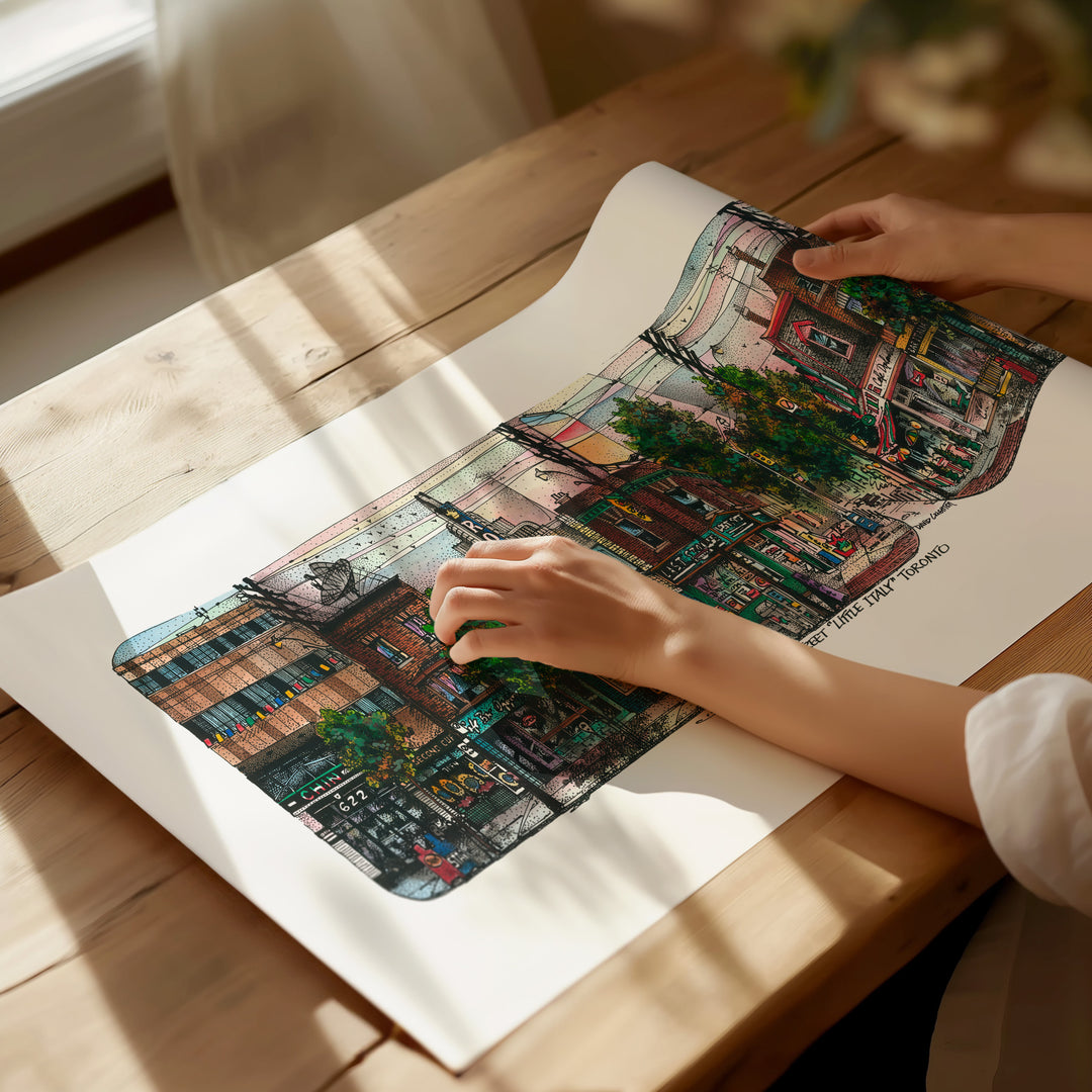 Beautiful illustration of Little Italy from Toronto Art Shop on a wooden desk, dappled in sunlight. 
