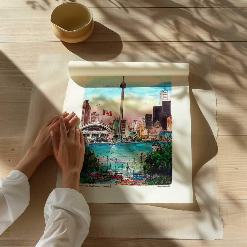 Beautiful illustration of The Toronto CN Tower from Toronto Art Shop on a wooden desk, dappled in sunlight. 