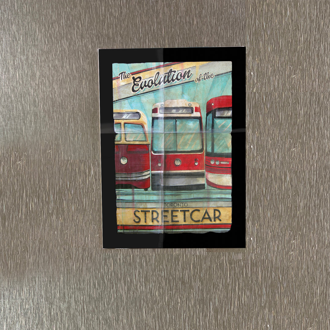 The Evolution of the Toronto Streetcar Fridge Magnet on a stainless steel refrigerator