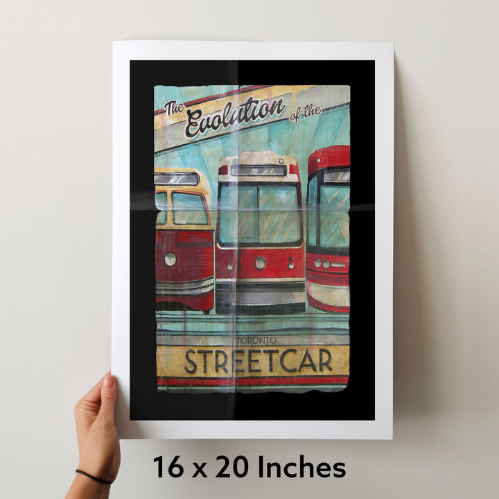 Toronto Streetcars over time in a 16 x 20 inch poster being held by a hand