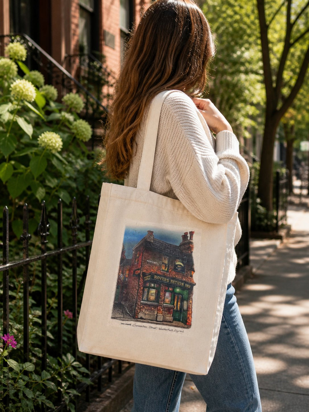 Woman with Rovers Return Canvas Art Tote on her shoulder on a city street in the summer
