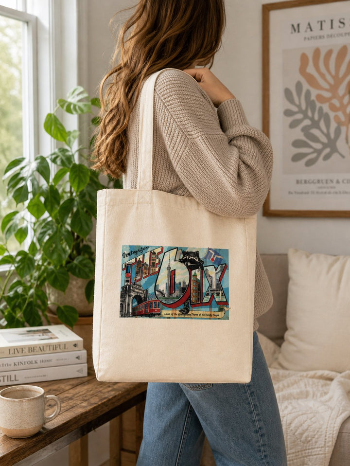 Woman in shop with a hip The Six Tote bag on her shoulder.  Looking Cool